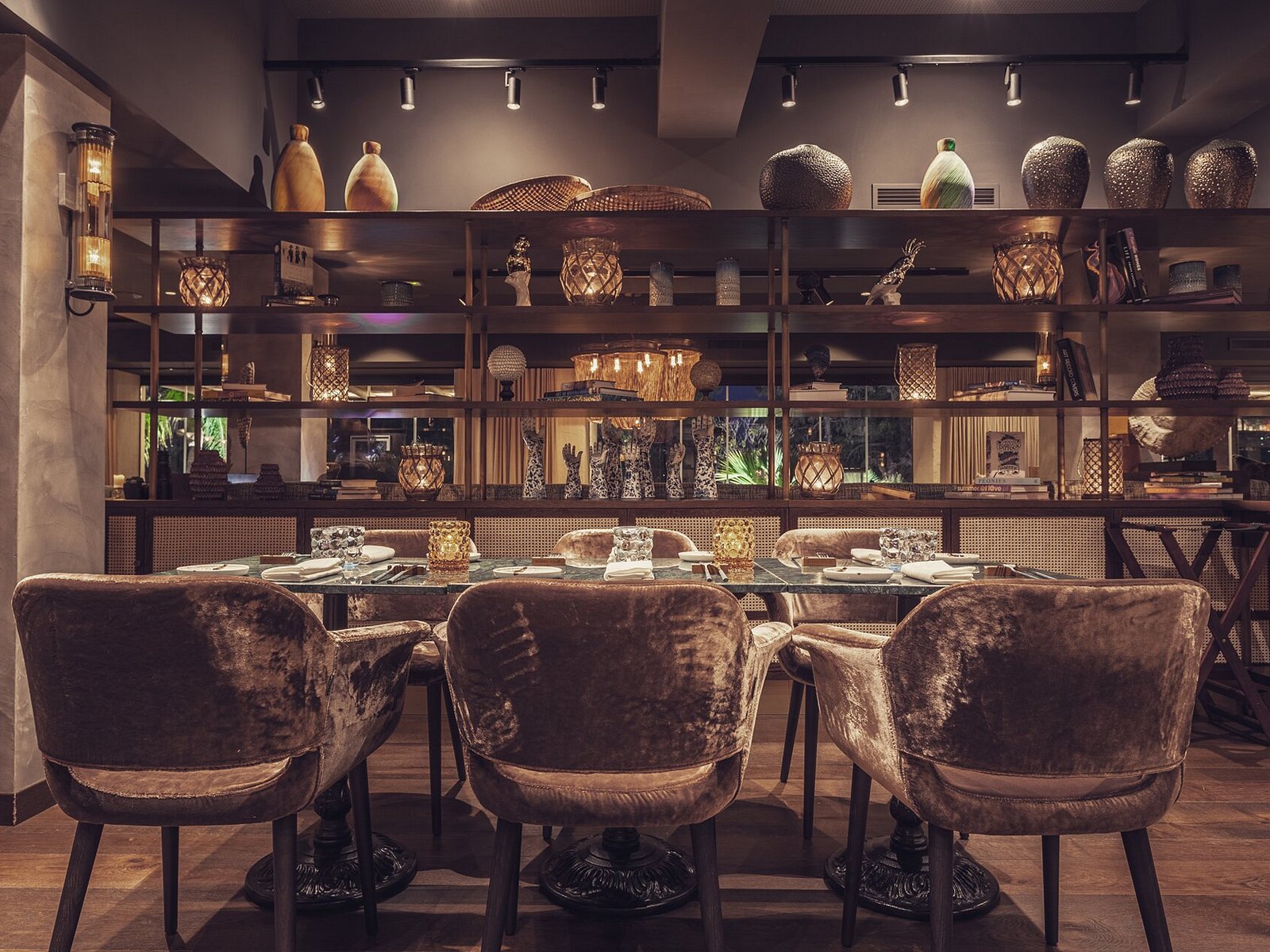 Boho Club Marbella restaurant interior with velvet chairs